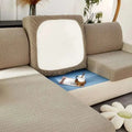Cream stretchy universal sofa cover in beige textured fabric with white cushion insert for versatile protection