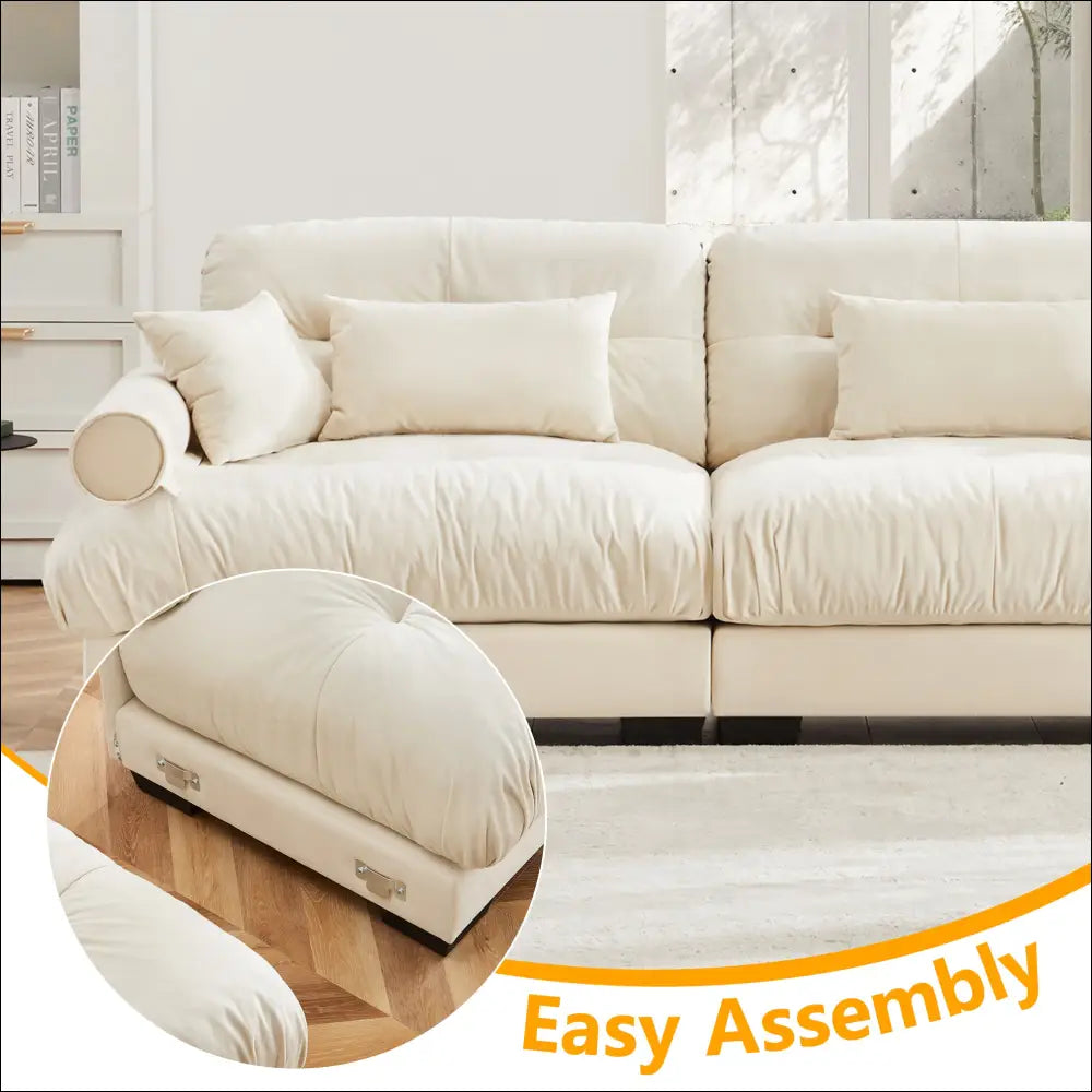 Cream velvet size modern sofa with cream leather tufted cushions and round bolster armrests in a sleek design