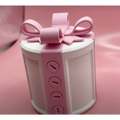 A white cylindrical valentine day gift box with a creative bowknot pink ribbon bow and four circular button details