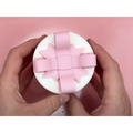 A white circular valentine day gift box with a delicate creative bowknot pink ribbon bow on top