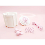 White plastic modular shelving system with pink ribbon bow accents and circular cutouts for valentine day gift display
