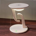 White modern charger suspension lamp with curved sculptural base and glowing light as smart wireless phone charger