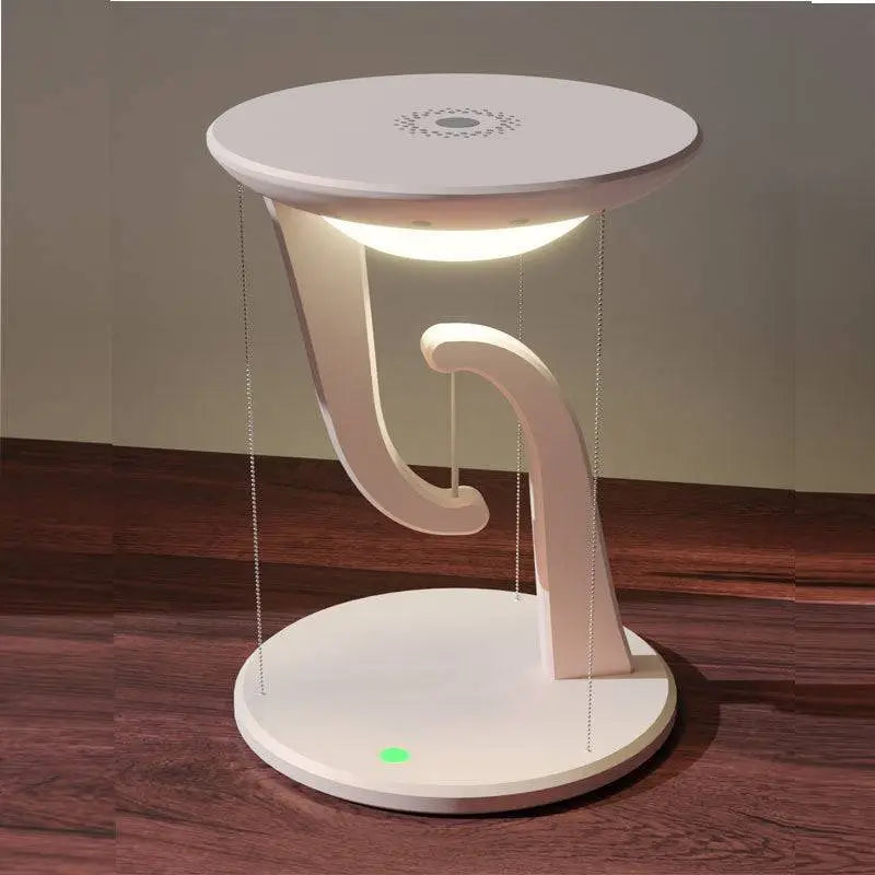 White modern charger suspension lamp with curved sculptural base and glowing light as smart wireless phone charger