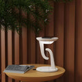 White modern charger suspension lamp with sleek curved design and integrated smart wireless phone charging pad