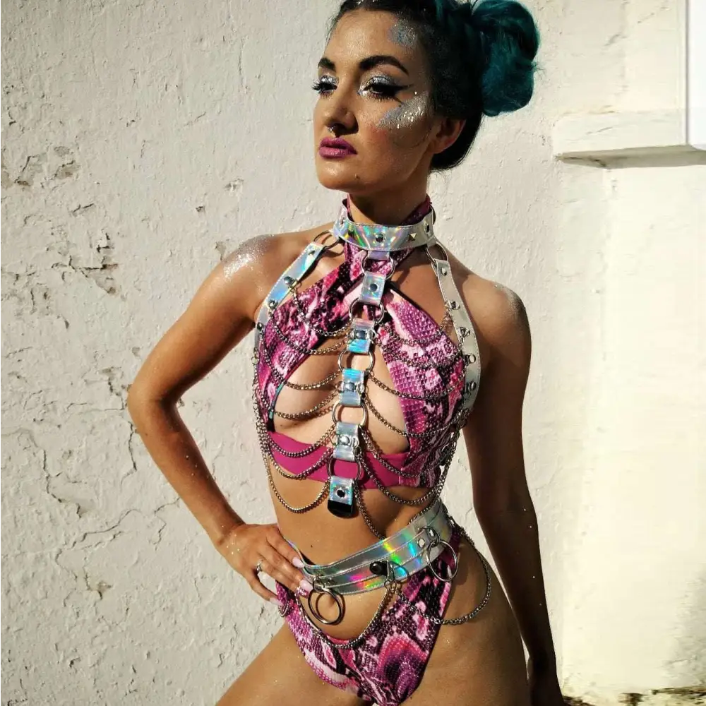 Creative versatile laser ladies belt bodysuit in shimmering pink snakeskin pattern with metallic silver chains and hardware