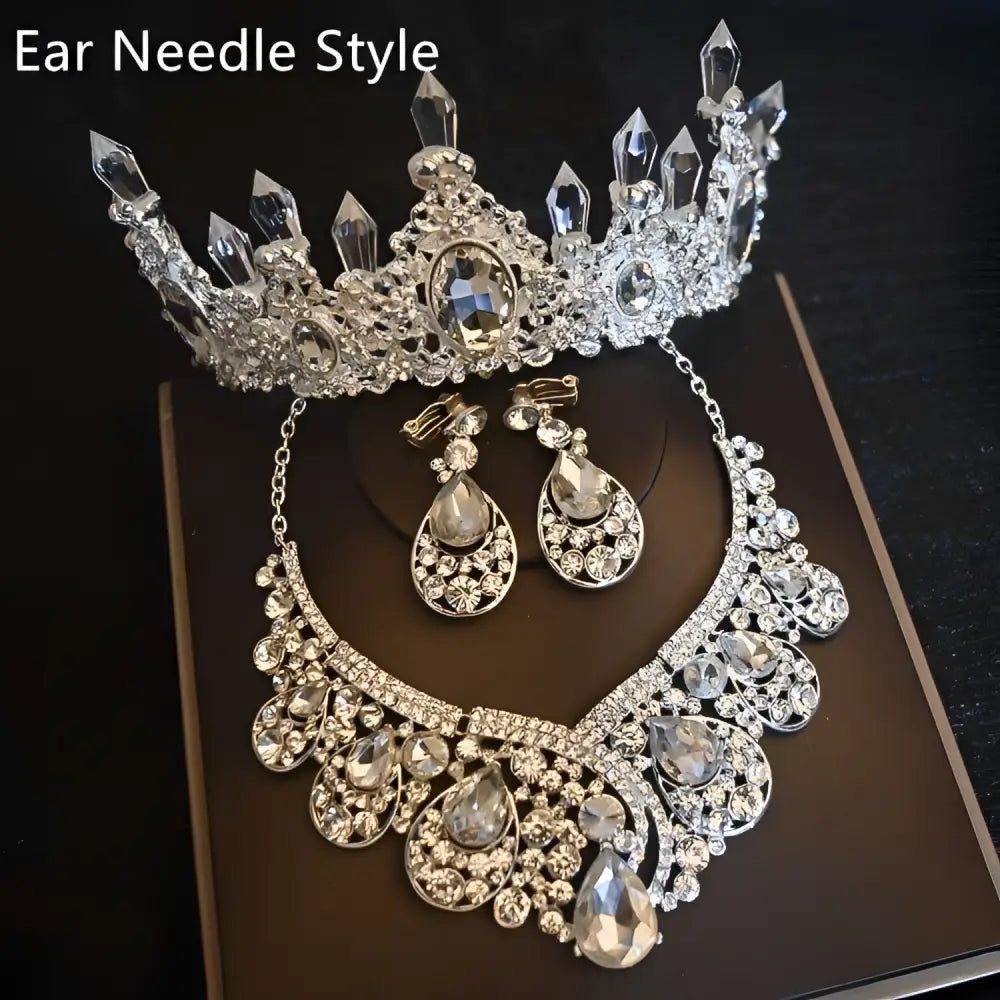Silver ear needle style crystal bridal headdress adorned with clear crystals and central oval gemstone for flowers wedding hair