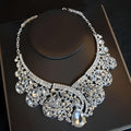 A sparkling silver crystal bridal headdress necklace with clear teardrop and round crystals in an ornate flowers design