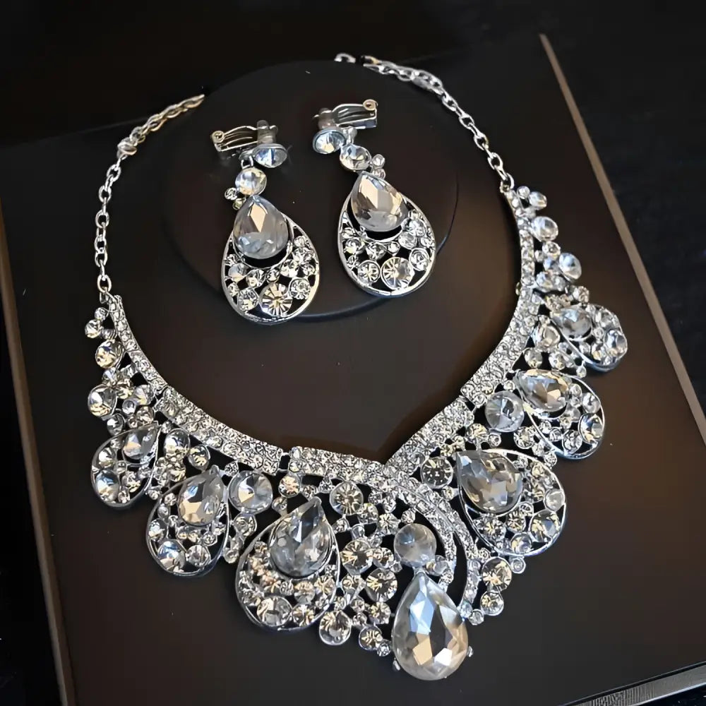 Crystal bridal headdress flowers jewelry set featuring a silver tiara with clear crystals and matching earrings and necklace