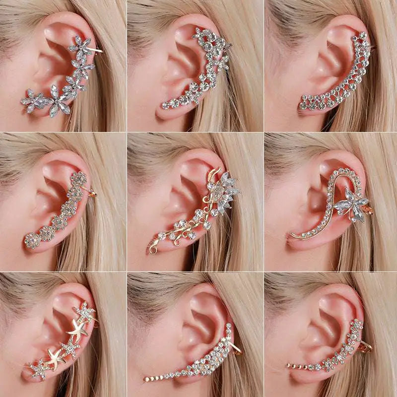 A collection of silver and gold rhinestone ear cuffs featuring crystal butterfly flower and intricate floral starfish designs