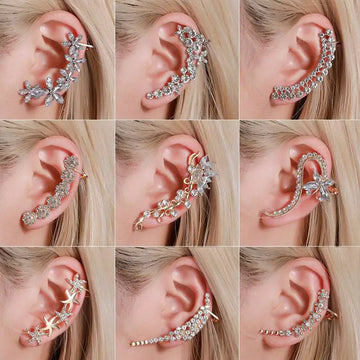 A collection of silver and gold rhinestone ear cuffs featuring crystal butterfly flower and intricate floral starfish designs