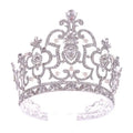 A sparkling silver crystal crown catwalk tiara adorned with intricate pearls and crystal embellishments