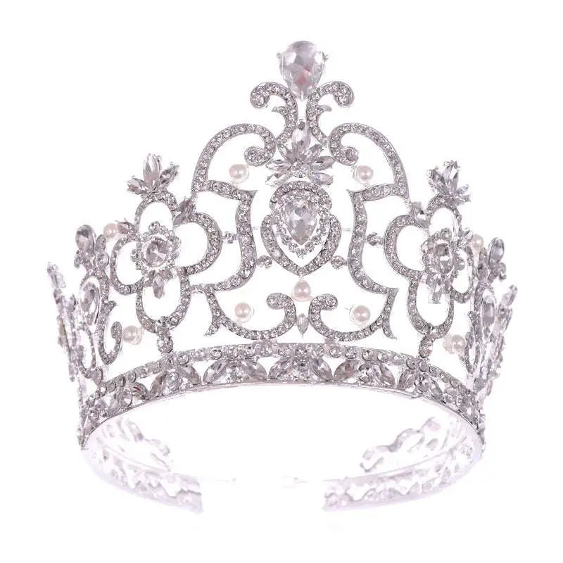 A sparkling silver crystal crown catwalk tiara adorned with intricate pearls and crystal embellishments