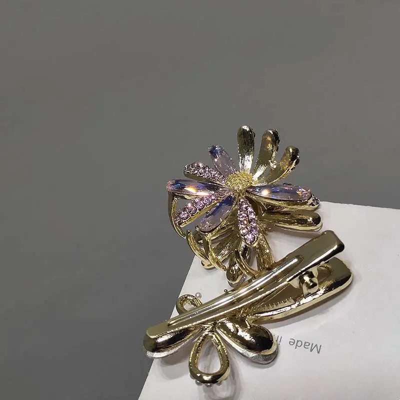 Gold-toned crystal daisy metal grab clip with floral design and sparkling purple and clear crystals clip sweet accessory