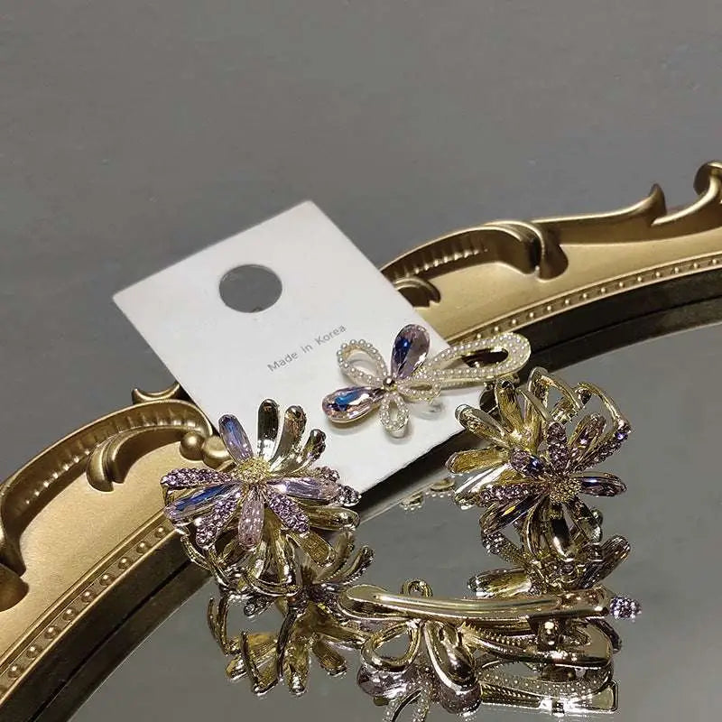 Gold-toned crystal daisy metal grab clip with floral design and sparkling purple and clear crystals clip sweet accessory