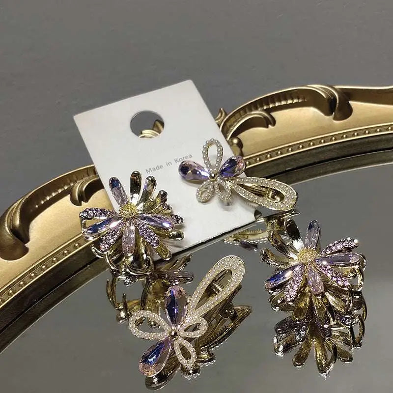 Crystal daisy metal grab clip featuring purple and silver crystal flower design on gold-toned metal sweet accessory