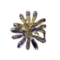 A gold-toned crystal daisy metal grab clip featuring deep blue and purple crystals on a flower-shaped brooch