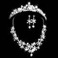 Sparkling silver tiara with clear crystals and white pearls paired with matching crystal flower necklace earrings
