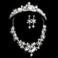 Sparkling silver bridal headdress set with clear crystals and pearls featuring a crystal flower necklace and earrings