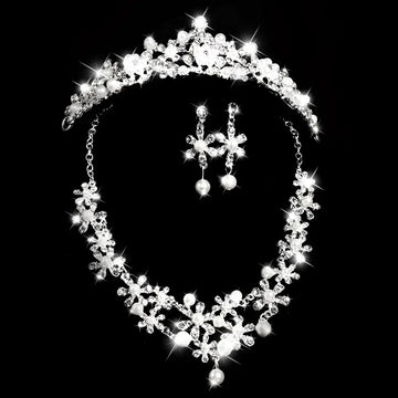 Sparkling silver bridal headdress set with clear crystals and pearls featuring a crystal flower necklace and earrings