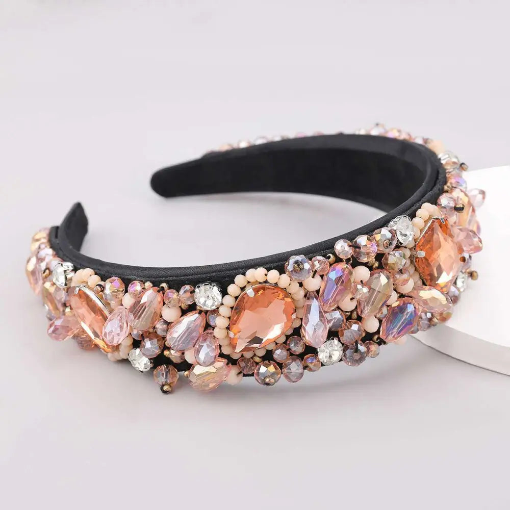 A glamorous black crystal geometric glass drill rhinestone headband with peach rose gold and clear iridescent beads