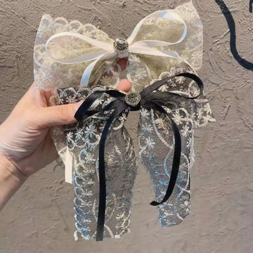 Delicate two-toned lace bow barrette with cream satin ribbon black velvet trim and elegant crystal lace central metallic button