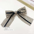 Elegant crystal lace bow barrettes for women featuring a delicate silver lace bow with black ribbon and pearl clasp