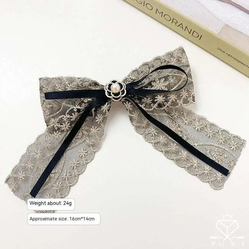 Elegant crystal lace bow barrettes for women featuring a delicate silver lace bow with black ribbon and pearl clasp