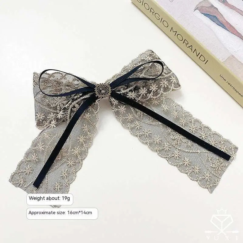 Elegant silver lace bow barrette with black satin ribbon and central metallic button for women’s crystal lace barrettes