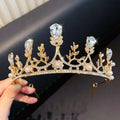 A golden crystal pearl girls princess crown headdress with clear teardrop crystals delicate leaves and pearls