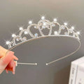 A sparkling silver girls princess crown headdress with clear and blue rhinestones in a heart-shaped design