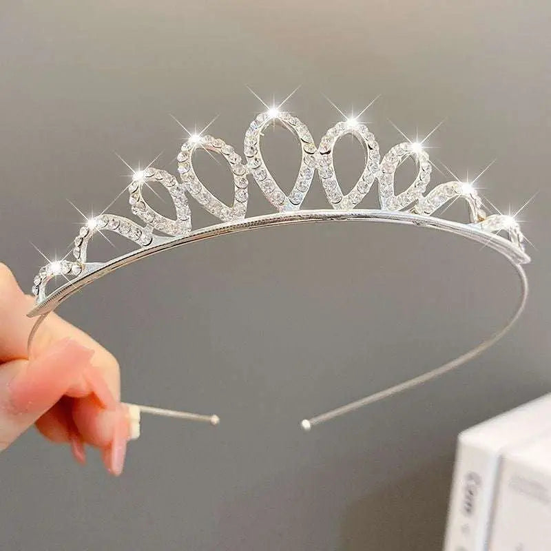 A sparkling silver girls princess crown headdress with clear rhinestones in an elegant heart-shaped crystal pearl girls design