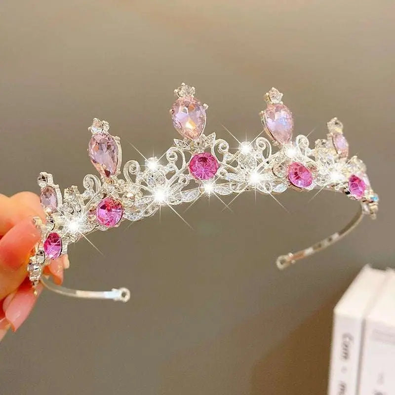 A sparkling silver crystal pearl girls princess crown headdress adorned with pink and clear crystals in intricate design