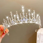 A sparkling silver girls princess crown headdress with clear and light blue crystal pearl teardrop crystals