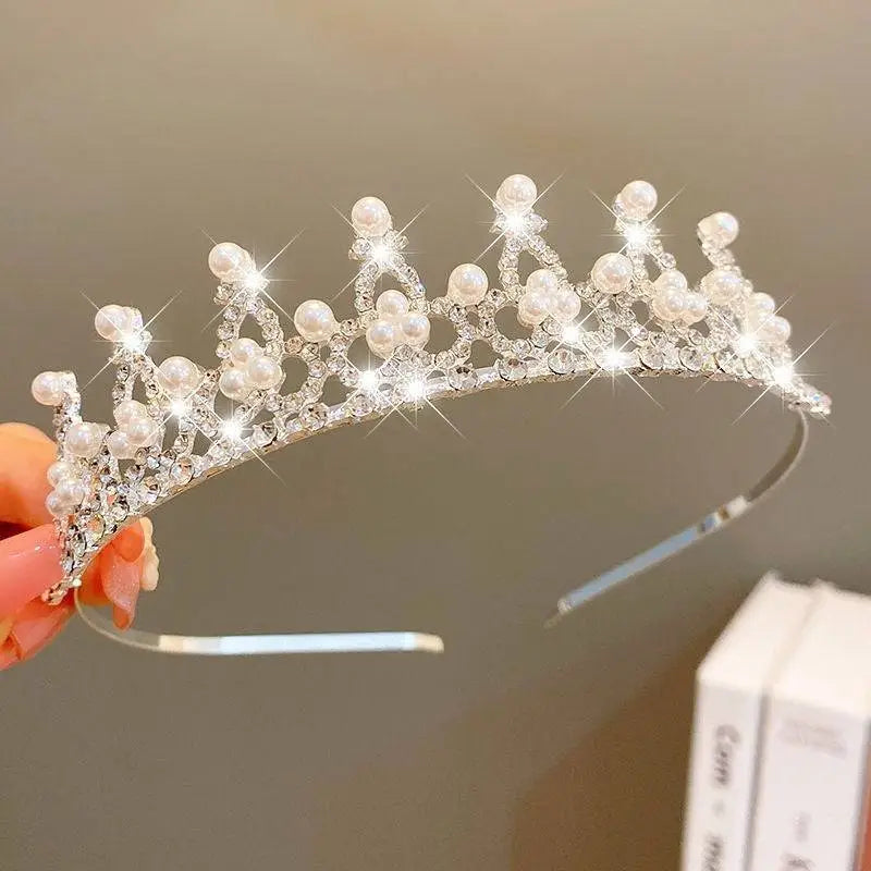 A sparkling silver girls princess crown headdress adorned with clear crystals and white pearls crystal pearl girls