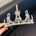 A sparkling silver crystal pearl girls princess crown headdress with clear crystals pearls and eiffel tower design