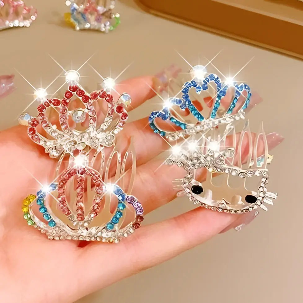 A hand holds crystal pearl girls princess crown headdress combs with colorful rhinestones on silver metal bases