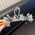 A sparkling silver girls princess crown headdress with crystal pearl details and interlocking swan rhinestone design
