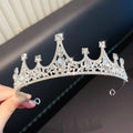A sparkling silver girls princess crown headdress adorned with clear crystals and intricate lace-like metalwork