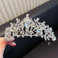 A sparkling silver crystal pearl girls princess crown headdress with intricate leaf and floral designs and clear crystals