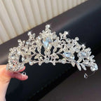 A sparkling silver crystal pearl girls princess crown headdress with intricate leaf and floral designs and clear crystals