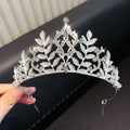 A sparkling silver girls princess crown headdress with intricate leaf designs and embedded crystals for crystal pearl girls