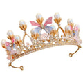 A delicate gold girls princess crown headdress adorned with pearls pastel bows and sparkling crystals