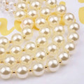 A crystal pearl long necklace featuring cream-colored imitation pearls separated by gold-toned spacers