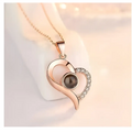 Rose gold crystal pendant necklace with dark round gemstone and elegant gift box symbolizing everlasting love