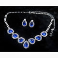 A customizable bride jewelry color diamond earrings set featuring a silver necklace and royal blue teardrop stones with crystals