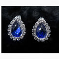 A pair of customizable bride jewelry color diamond earrings set with vibrant blue stones and clear crystals in silver