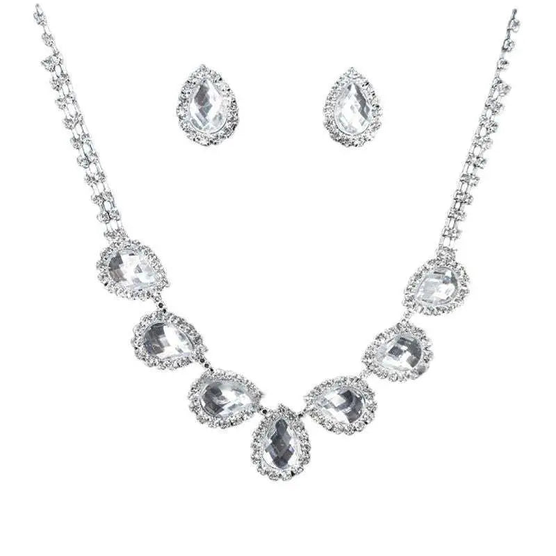 A customizable bride jewelry diamond earrings set with a silver necklace and teardrop clear crystals in rhinestone bezels