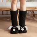 Black plush cute cartoon dog floor socks with white ears and nose details designed for indoor comfort