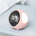 Cute pixel expression digital electronic cute pink spherical alarm clock with black display showing 06:30 and white illuminated panel