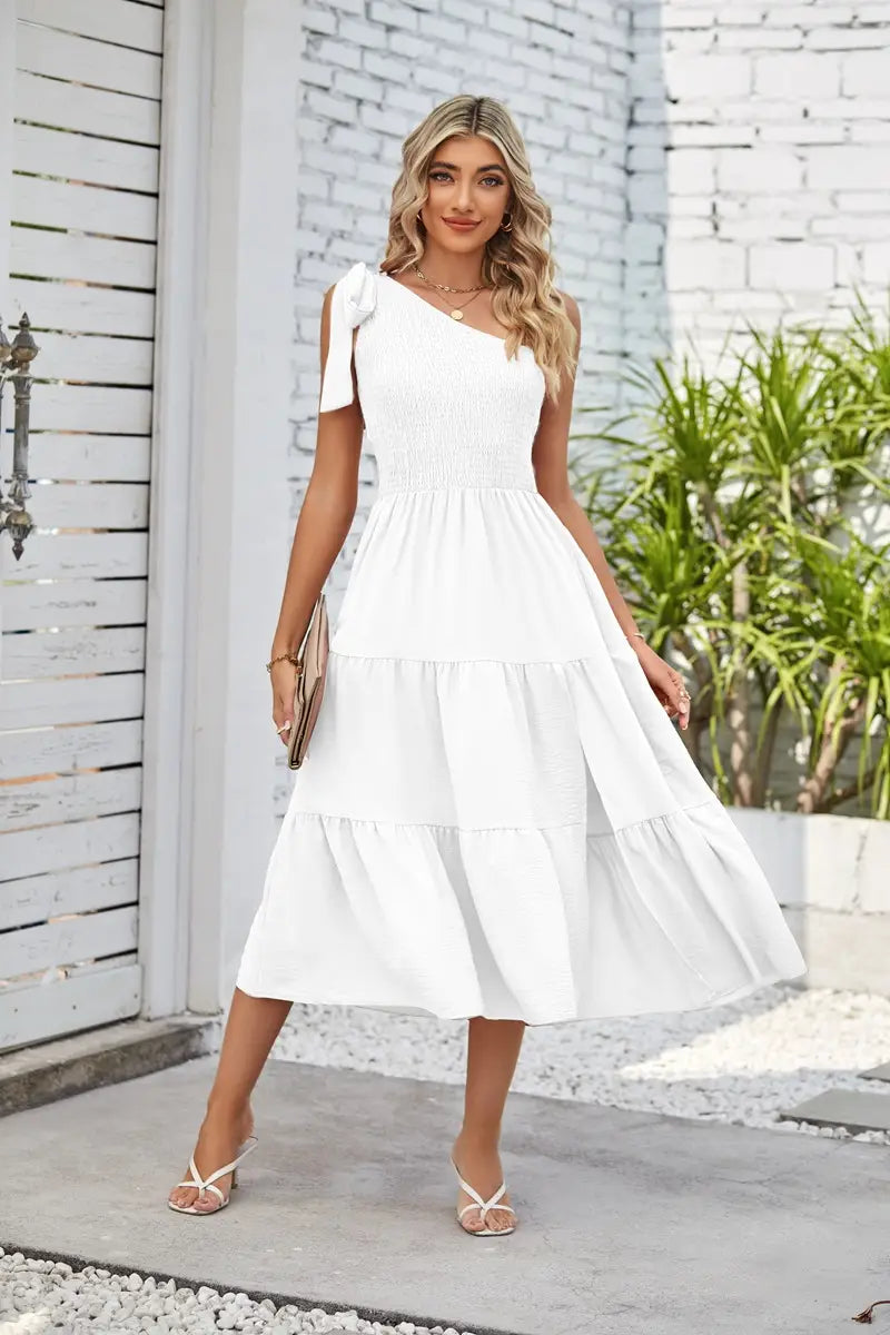 white tiered midi dress with a single shoulder strap and ruffled hem featuring a pleated layered hem design in a hem split dress style